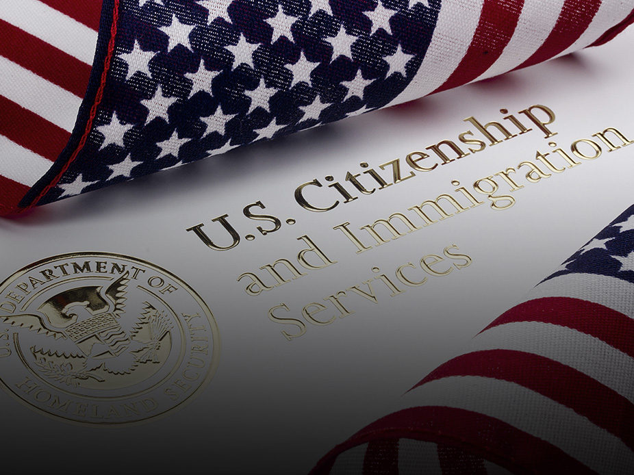 American flag next to the U.S. Citizenship and Immigration Services seal.
